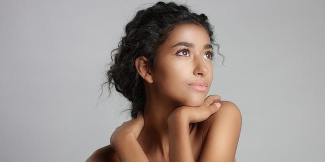 Happy serene young woman with beautiful olive skin.